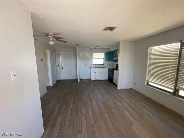 4861 Regal, Bonita Springs, FL 34134 - unfurnished living room with dark hardwood / wood-style flooring, ceiling fan, and sink