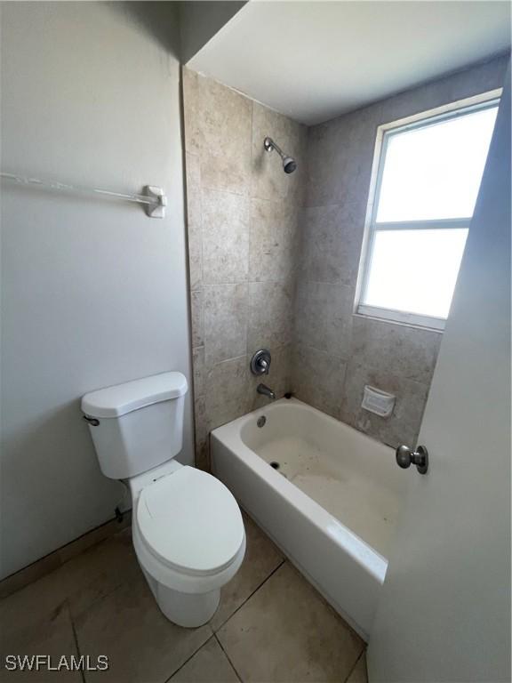 4861 Regal, Bonita Springs, FL 34134 - bathroom with tile patterned floors, tiled shower / bath combo, and toilet