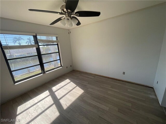 4861 Regal, Bonita Springs, FL 34134 - spare room with dark hardwood / wood-style flooring and ceiling fan