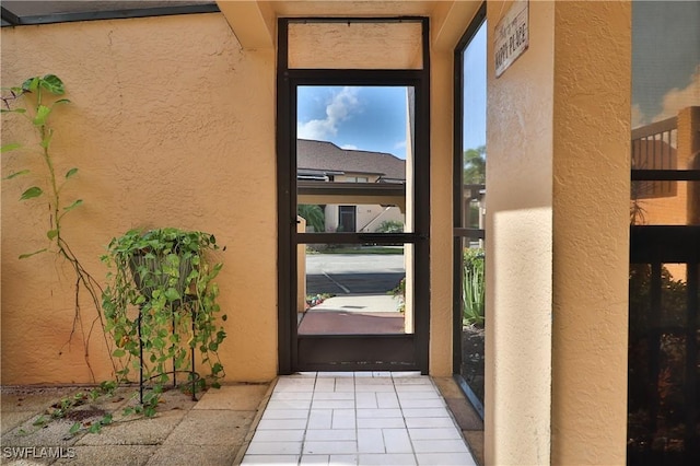 property entrance featuring stucco siding