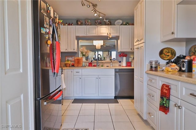 kitchen featuring sink, white cabinets, light tile patterned floors, and appliances with stainless steel finishes