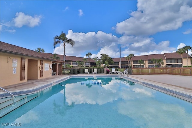 pool featuring fence and a patio