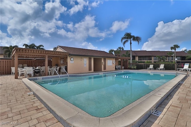 view of swimming pool with a pergola and a patio