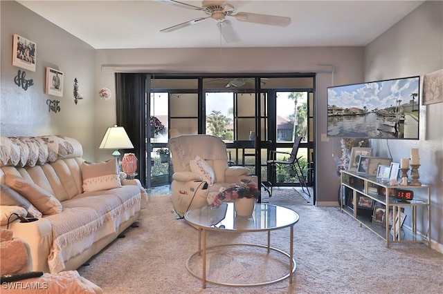 carpeted living room with french doors and ceiling fan