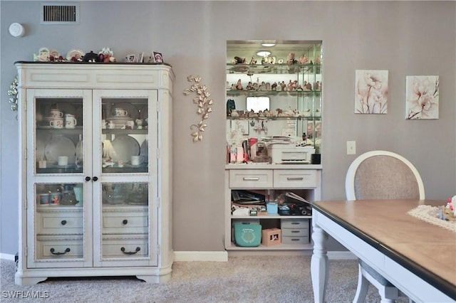 bar with light carpet and white cabinets