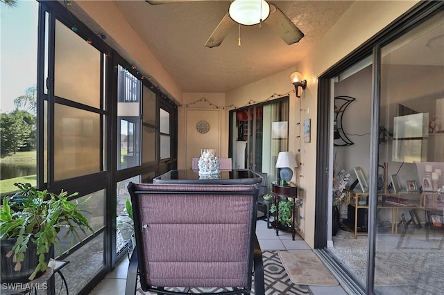 sunroom / solarium with a ceiling fan