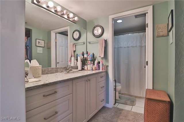 bathroom with tile patterned floors, vanity, and toilet