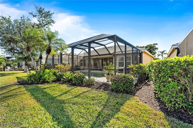 back of house featuring glass enclosure, a lawn, and an outdoor pool