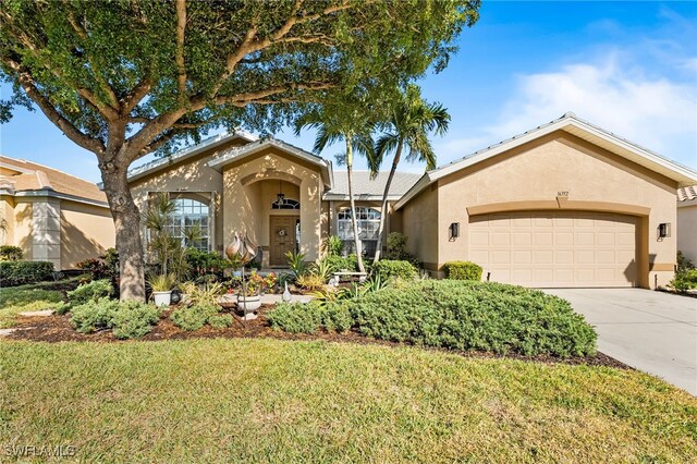 view of front of house featuring concrete driveway, a front lawn, an attached garage, and stucco siding