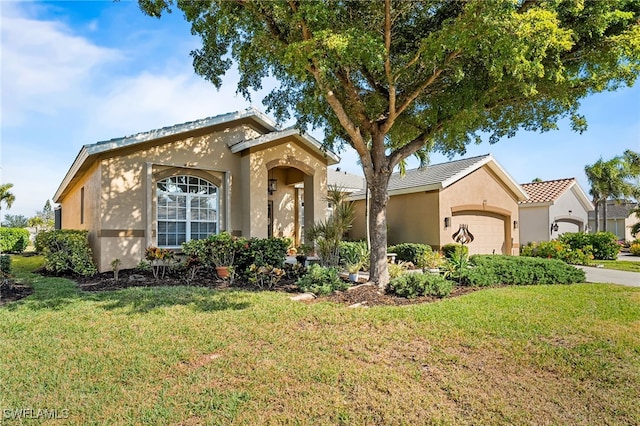 view of front of property featuring a front lawn, driveway, an attached garage, and stucco siding