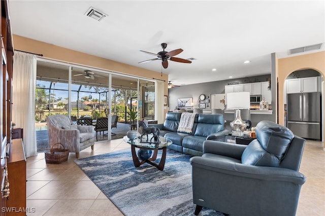 living room featuring visible vents, ceiling fan, and light tile patterned floors