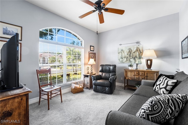 living room featuring ceiling fan, carpet, and baseboards