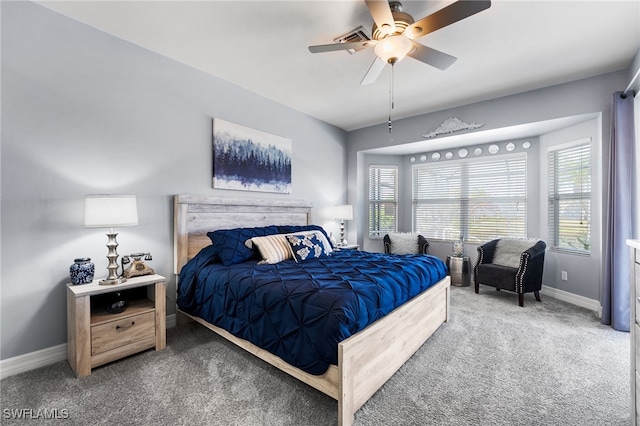 carpeted bedroom with ceiling fan and baseboards