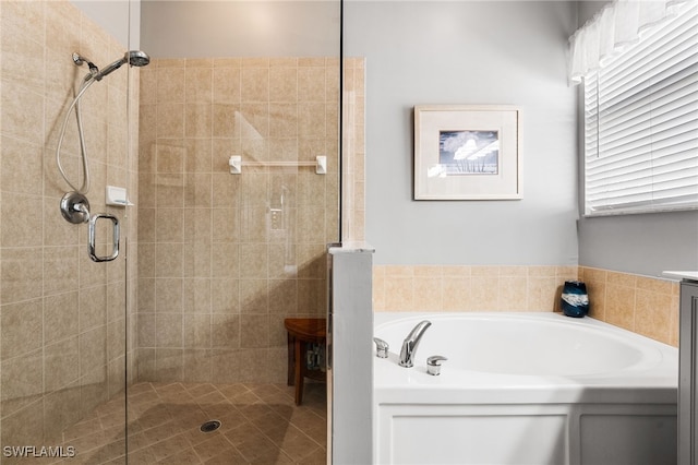 full bathroom featuring a stall shower and a garden tub