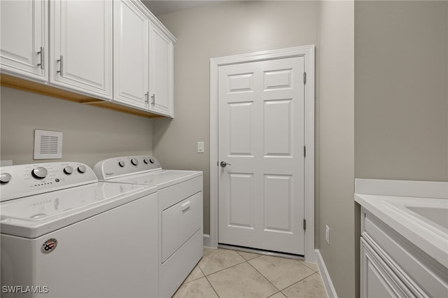 washroom with cabinets, light tile patterned flooring, and independent washer and dryer