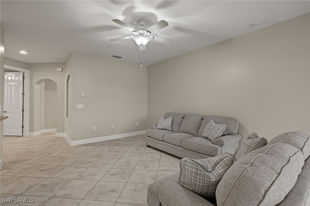 living room with ceiling fan and light tile patterned floors