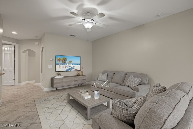 living room with ceiling fan and light tile patterned flooring