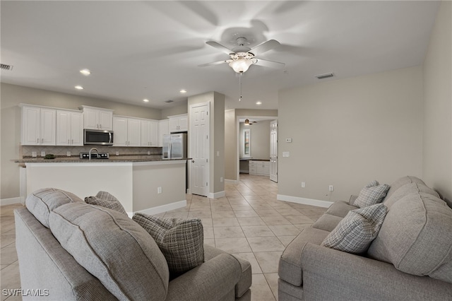 tiled living room with ceiling fan