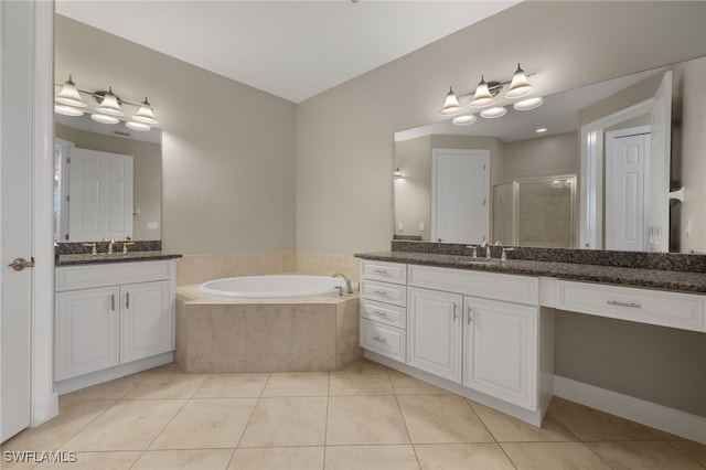 bathroom with vanity, tile patterned flooring, and plus walk in shower