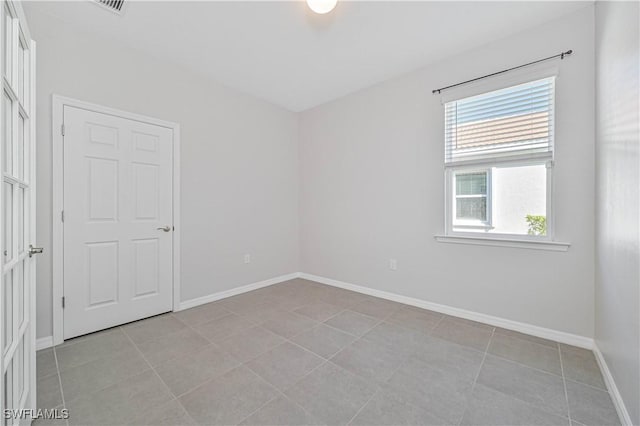 unfurnished room with light tile patterned floors