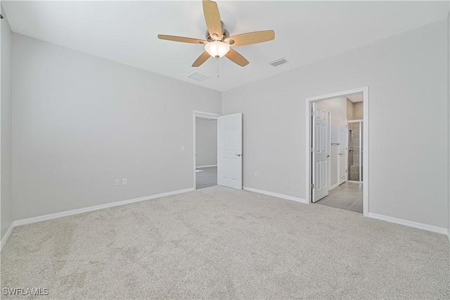 unfurnished bedroom with connected bathroom, ceiling fan, and light colored carpet