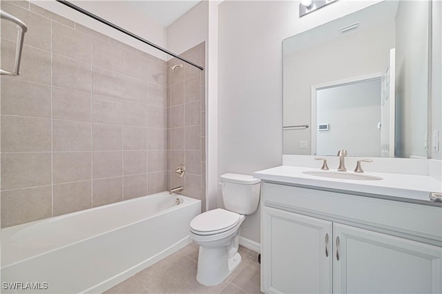 full bathroom featuring tile patterned floors, vanity, toilet, and tiled shower / bath