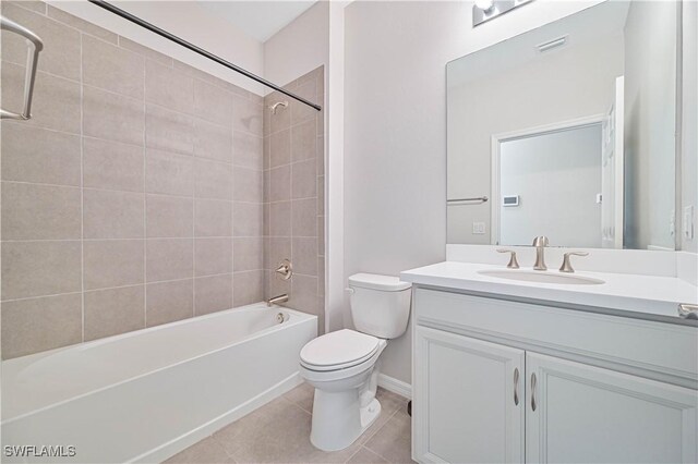 15133 Ligustrum Ln, Alva, FL 33920 - bathroom featuring toilet, vanity, washtub / shower combination, tile patterned floors, and baseboards