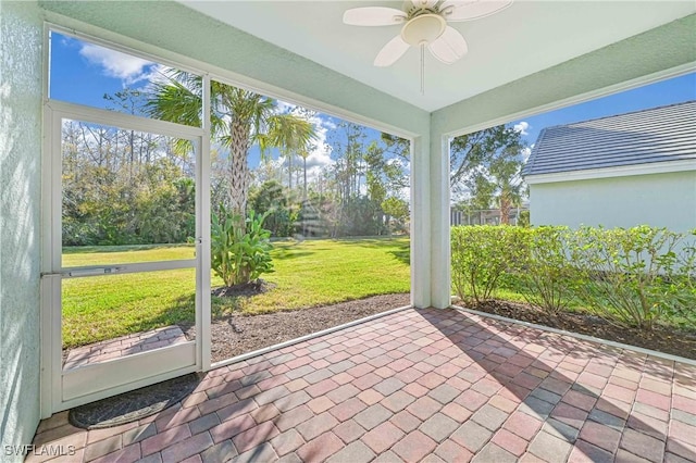 sunroom featuring ceiling fan