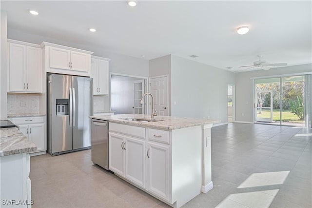 15133 Ligustrum Ln, Alva, FL 33920 - kitchen featuring appliances with stainless steel finishes, a sink, a ceiling fan, light stone countertops, and white cabinetry