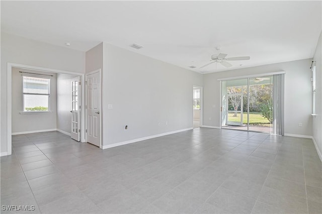 unfurnished room with ceiling fan and light tile patterned flooring