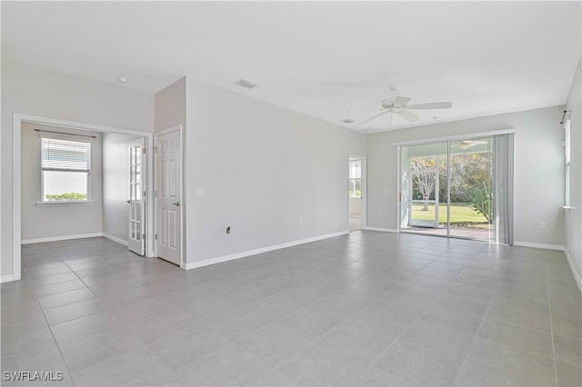 15133 Ligustrum Ln, Alva, FL 33920 - unfurnished room featuring healthy amount of natural light, ceiling fan, light tile patterned flooring, and baseboards