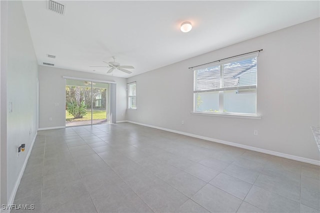 tiled spare room with ceiling fan