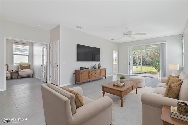 tiled living room with ceiling fan