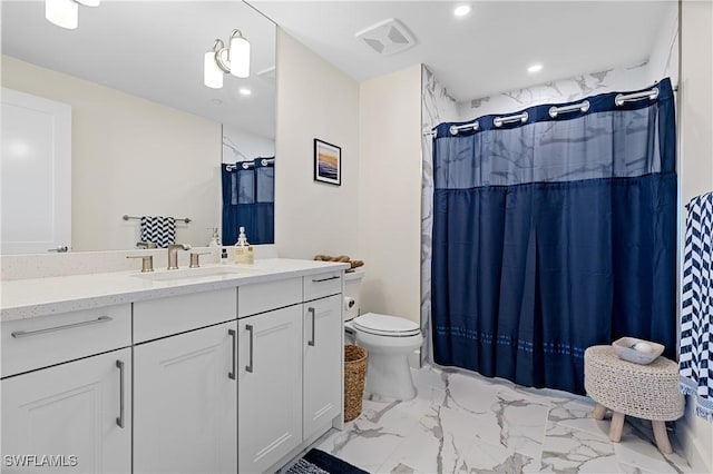 bathroom featuring toilet, vanity, and a shower with curtain