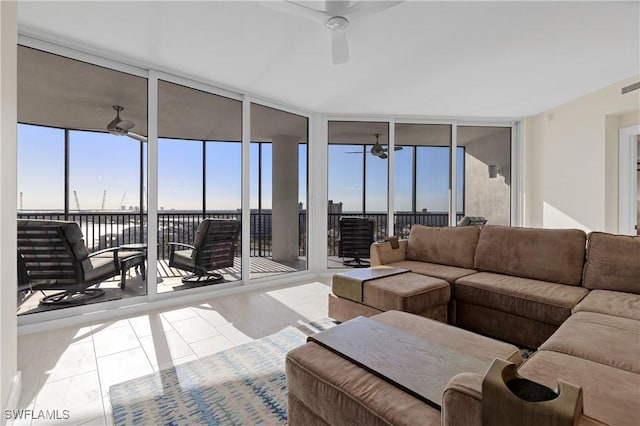 living room with floor to ceiling windows, light tile patterned flooring, and plenty of natural light