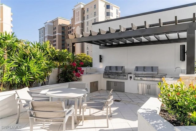 view of patio / terrace featuring sink, area for grilling, grilling area, and a pergola