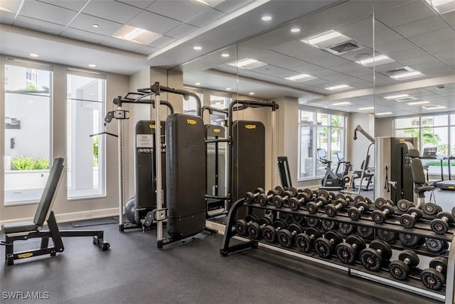 gym with a paneled ceiling