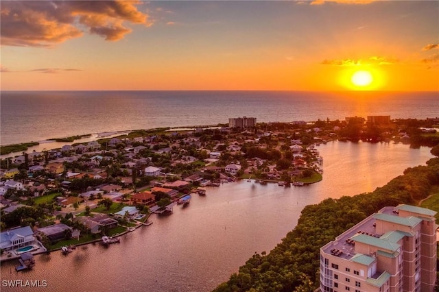 aerial view at dusk with a water view