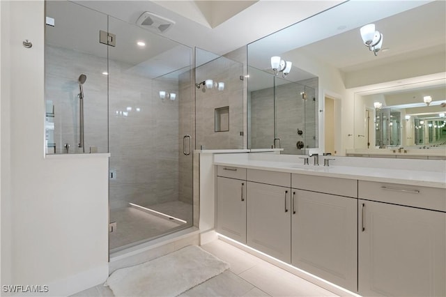 bathroom with vanity, tile patterned flooring, and a shower with shower door