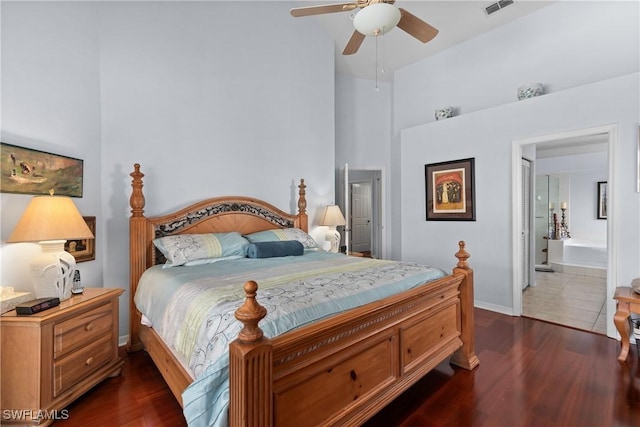 bedroom with lofted ceiling, ensuite bathroom, ceiling fan, and dark hardwood / wood-style floors