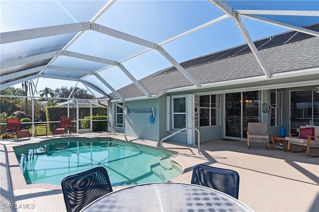 view of pool with a lanai and a patio