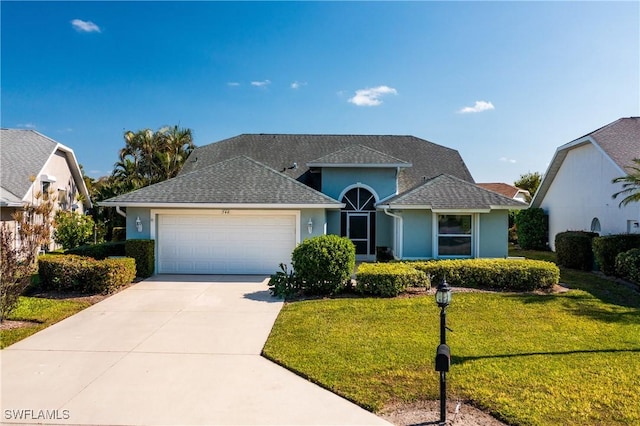 view of front of house with a front lawn and a garage