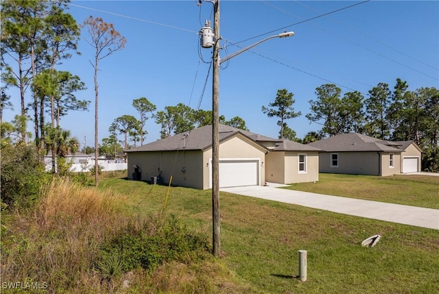 ranch-style home with a garage and a front lawn