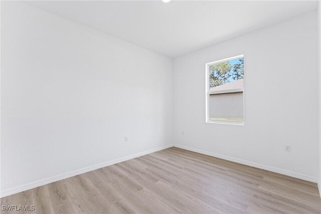 spare room with light hardwood / wood-style flooring