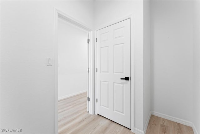 corridor with light hardwood / wood-style floors