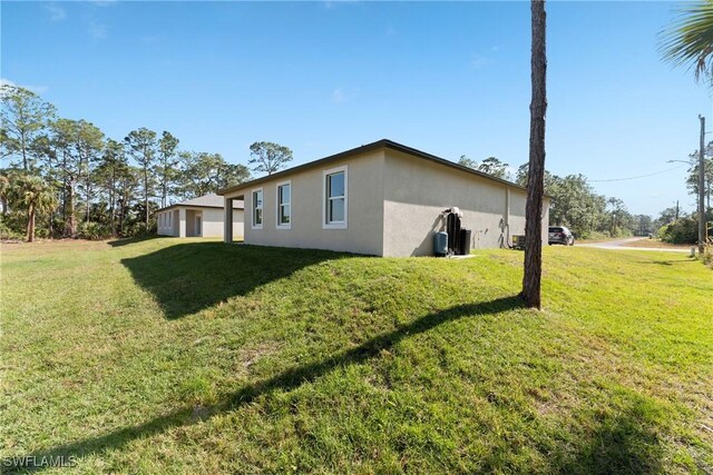 view of property exterior with a yard