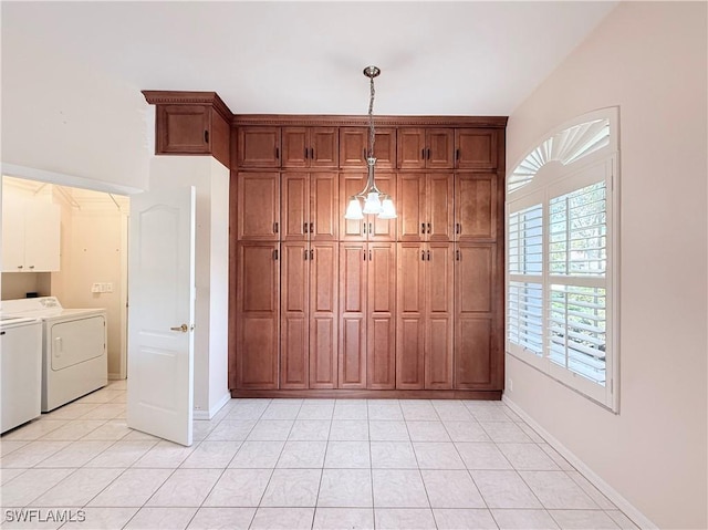 kitchen with washer and dryer, light tile patterned floors, and hanging light fixtures