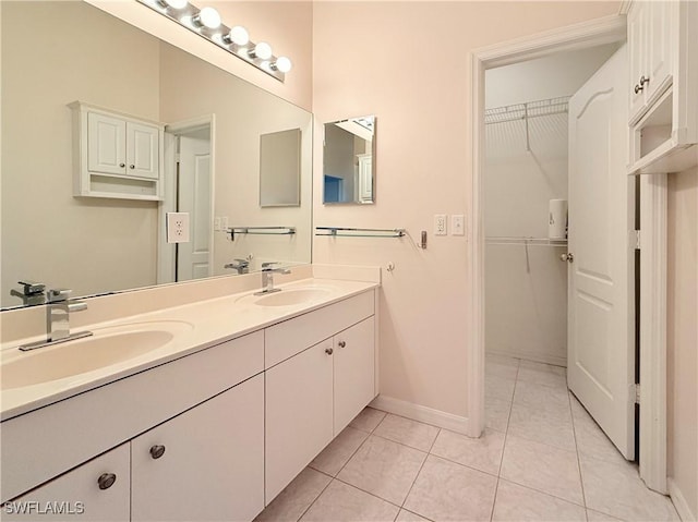 bathroom featuring tile patterned flooring and vanity