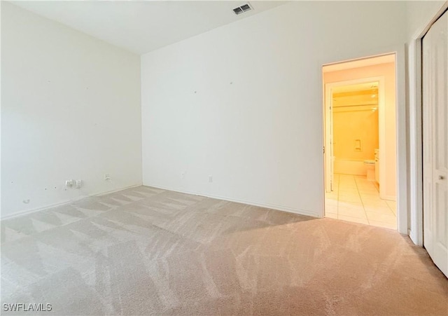 unfurnished room with light colored carpet