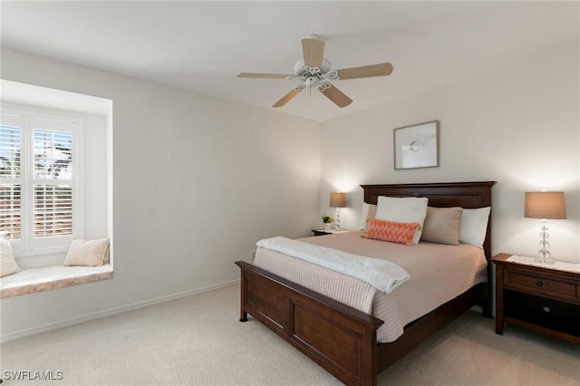 bedroom featuring ceiling fan and light carpet